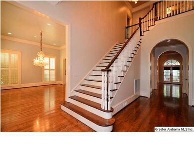 Two story foyer opening to formal dining room.   H