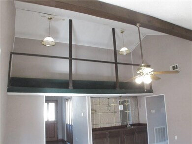 Additional view of den with cathedral ceilings and
