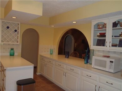 Kitchen. Archway/bar opens kitchen to the family room.
