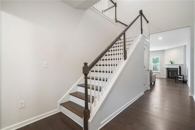Stairs featuring wood finished floors, baseboards, a fireplace, and recessed lighting