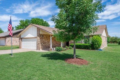 Ranch-style home with a garage and a front lawn