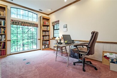 Spacious room used as a library and office space.