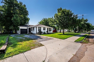 Single story home with driveway, a front yard, and an attached garage