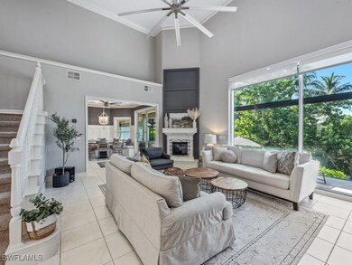 Living room featuring ceiling fan, a high ceiling,