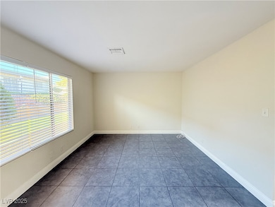 Spare room with baseboards and tile patterned floors
