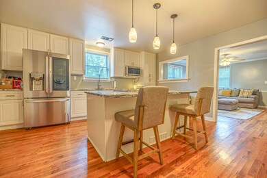 Kitchen featuring a kitchen breakfast bar, light s