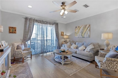 Living room featuring ceiling fan, recessed lighti
