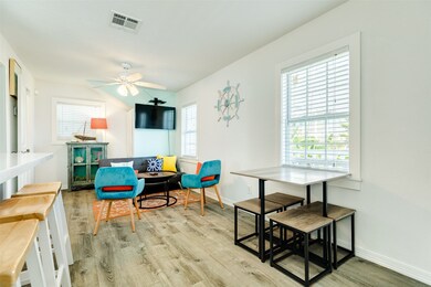 This bright living area features laminate wood flo
