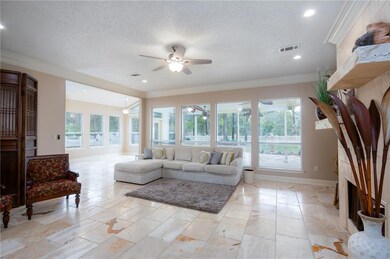 The den flows into the Sun Room and Kitchen