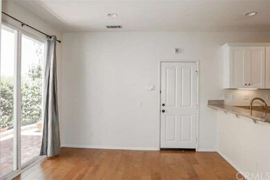 The spacious dining room features newer flooring, 