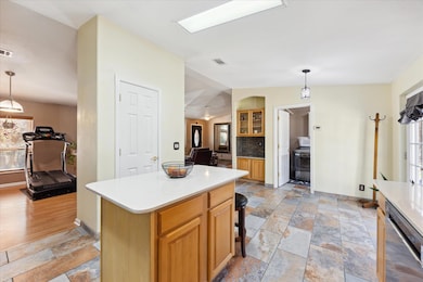 Kitchen featuring lofted ceiling, stone tile floo