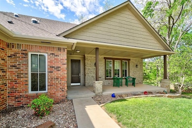 Entrance to property featuring brick siding, roof 