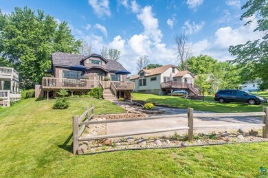 Rear view of house with a yard and a wooden deck