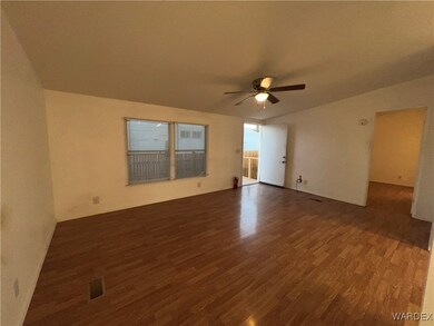 Spare room featuring visible vents, dark wood-styl