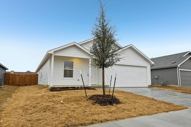 View of front facade with a garage and cooling uni