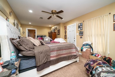 Bedroom featuring carpet, recessed lighting, and ceiling fan