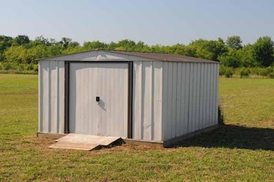 Store your lawn mower and garden tools in this storage bldg.