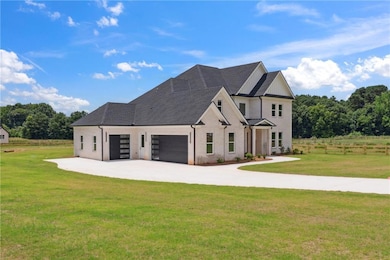 View of front facade with concrete driveway, a garage, and brick siding