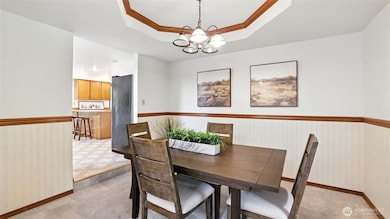 This formal dining space featuring beautiful tray ceiling offers the perfect space for intimate dinners or large gatherings!