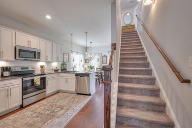 The kitchen includes all stainless appliances, a walk-in pantry, granite counters, undercabinet lighting, a tile backsplash along with seating at the bar.
