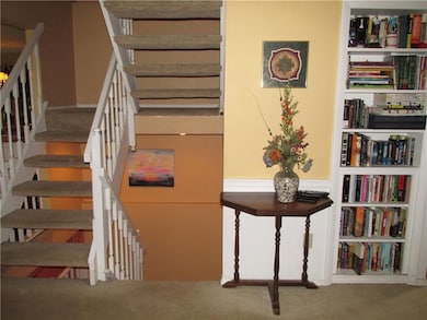 An open staircase connects the 3 levels and contri