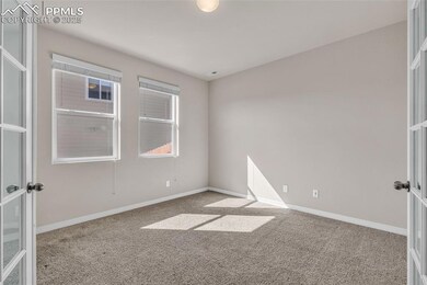 Unfurnished room featuring light colored carpet and french doors