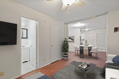 Living room featuring a textured ceiling, wood fi