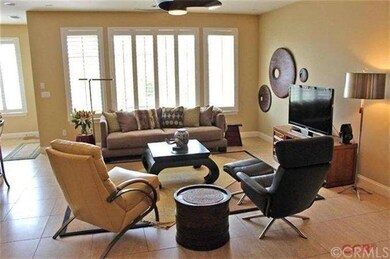 Lots of large windows featuring plantation shutter