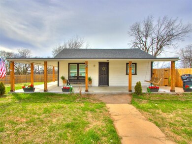 View of front of house featuring a front yard and fence