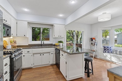 Bright & open eat-in kitchen with sliding glass door to deck, perfect for grilling & dining