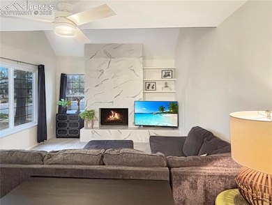 Living room featuring vaulted ceiling, carpet floo