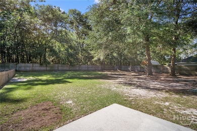 Patio area overlooking large backyard with garden