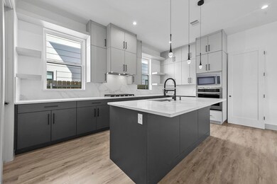Kitchen with pendant lighting, sink, a center isla