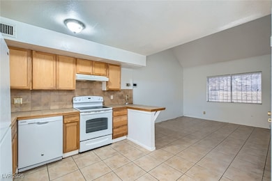 Kitchen with white appliances, under cabinet range