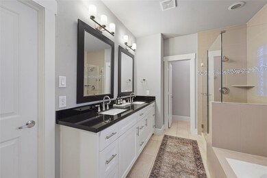 The Primary Bathroom features dual vanities, walk-