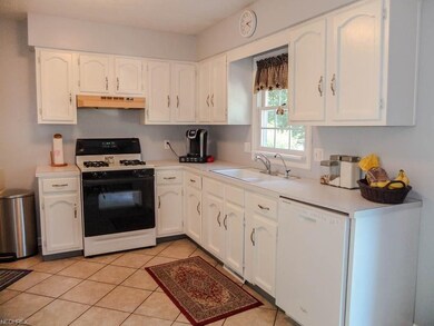 Fully applianced kitchen with tile flooring.