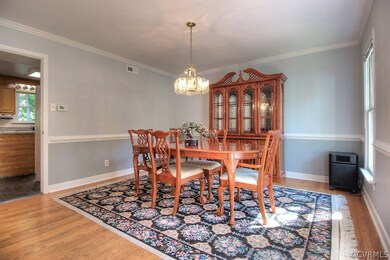 Large dining room with hardwood floors, chair rail