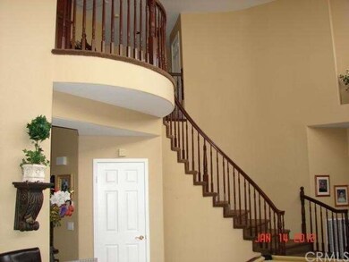Spiral stairway with vaulted ceilings in entry, li