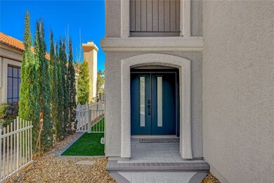 View of exterior entry featuring fence and stucco