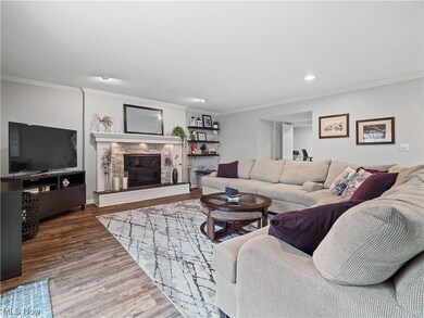 Huge family room features custom firepace surround and LVP wood-style floors