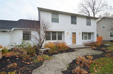 The stamped concrete walk and landscaping greets y