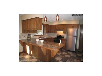 The kitchen features a new countertop, breakfast b