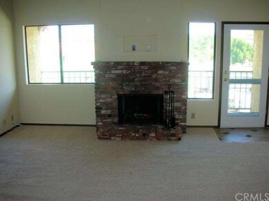 Wood fireplace in living room with door to balcony