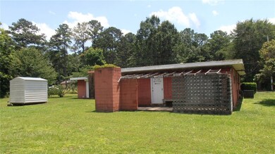 REAR VIEW. LARGE FLAT LOT. OUTSIDE BBQ ON PATIO.