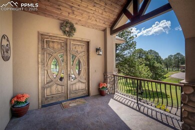 View of exterior entry double door and decorative railing