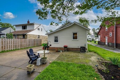 Back of property with a lawn and a patio area