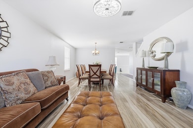Living room with wood finished floors and a chandelier