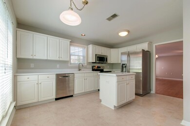 Stainless steel appliances with an ample island.