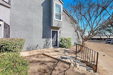 Property entrance with stucco siding and a patio