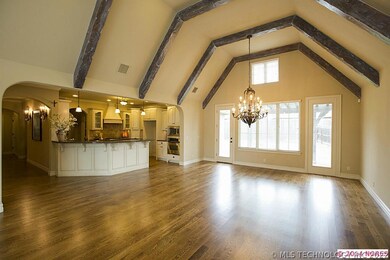 Greatroom  with vaulted beamed ceiling is open to